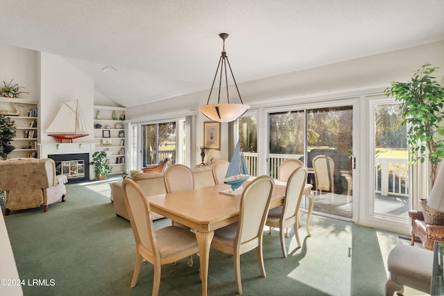 dining room with carpet floors, vaulted ceiling, a healthy amount of sunlight, and a textured ceiling