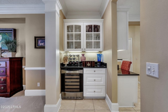 bar featuring white cabinetry, light tile patterned floors, wine cooler, and crown molding