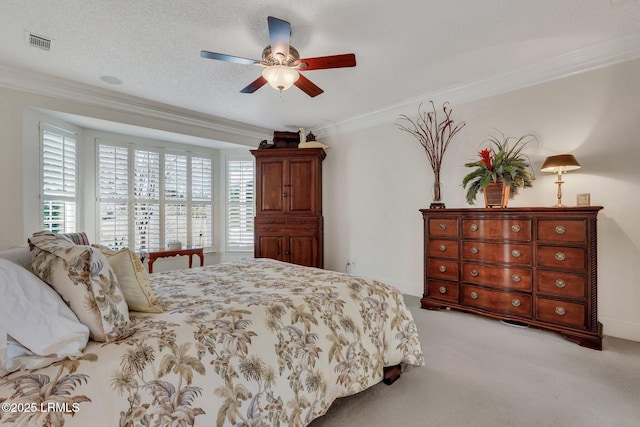 bedroom featuring light carpet, ceiling fan, crown molding, and a textured ceiling