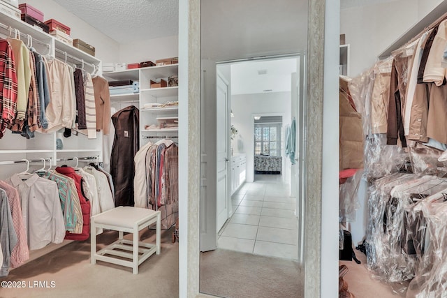 walk in closet with light tile patterned flooring