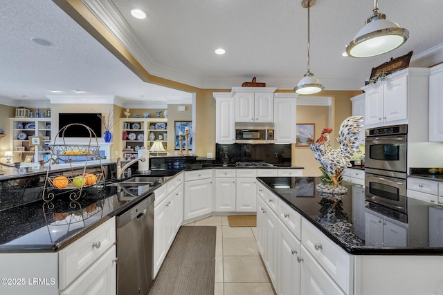 kitchen featuring white cabinetry, crown molding, light tile patterned floors, pendant lighting, and stainless steel appliances