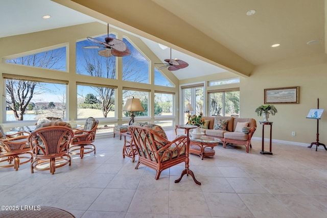 sunroom / solarium featuring plenty of natural light, lofted ceiling with beams, and ceiling fan