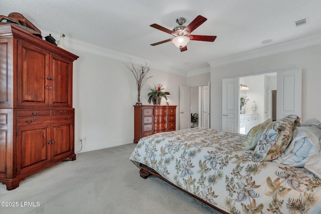 bedroom featuring ensuite bath, ornamental molding, ceiling fan, light carpet, and a textured ceiling