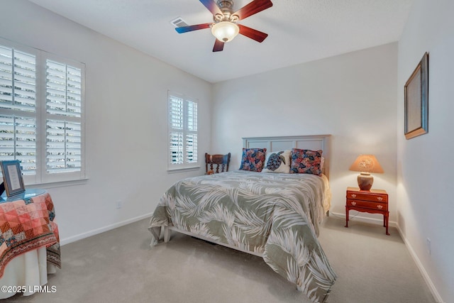 bedroom featuring ceiling fan and light carpet