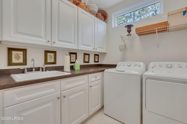 washroom with washer and dryer, sink, light tile patterned floors, and cabinets