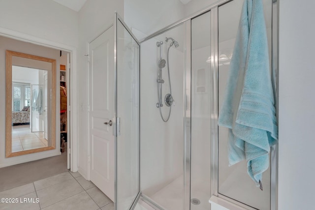 bathroom featuring a shower with shower door and tile patterned flooring