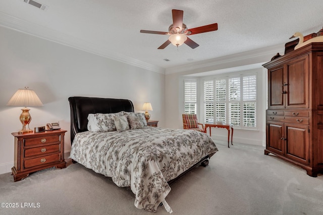 bedroom with ceiling fan, ornamental molding, light carpet, and a textured ceiling