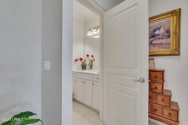 bathroom with ornamental molding and vanity