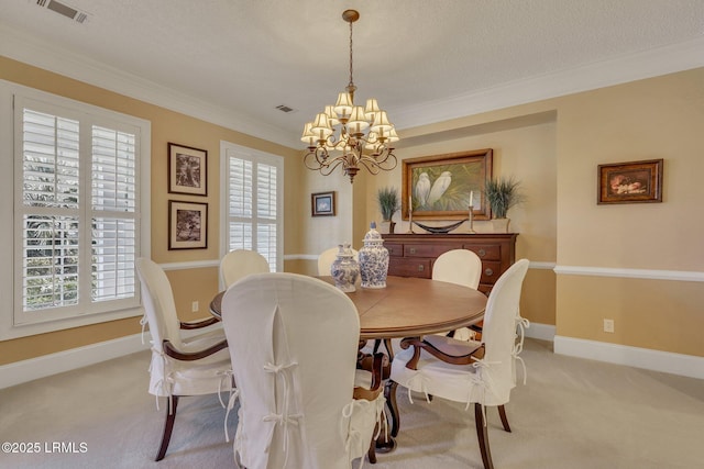 carpeted dining room with crown molding, plenty of natural light, a textured ceiling, and a chandelier