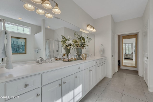 bathroom featuring walk in shower, vanity, and tile patterned flooring