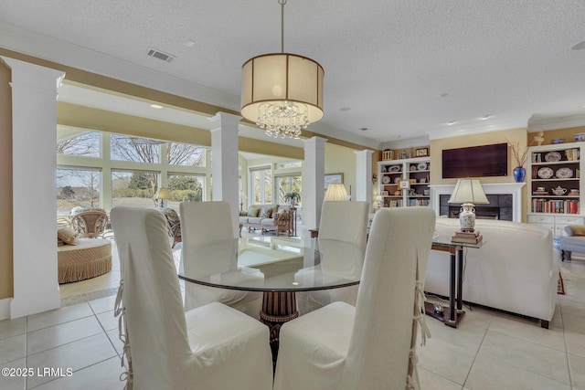 dining area with ornate columns, light tile patterned flooring, plenty of natural light, and ornamental molding