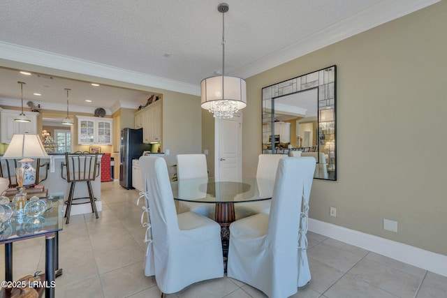 tiled dining area featuring a notable chandelier, crown molding, and a textured ceiling