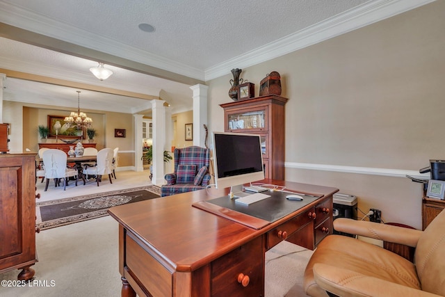 carpeted home office featuring a notable chandelier, crown molding, decorative columns, and a textured ceiling