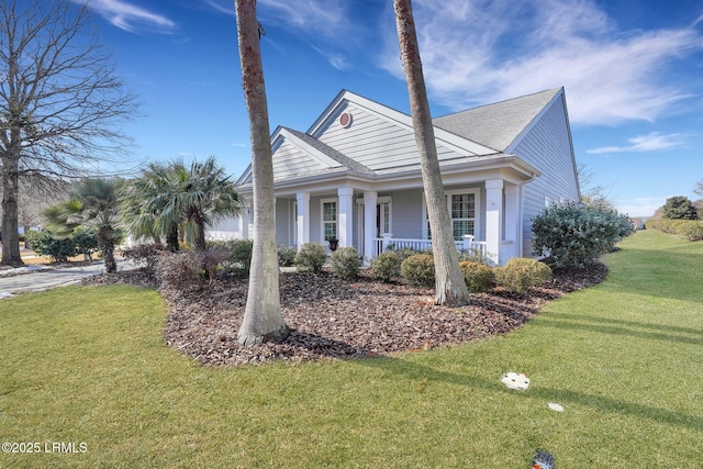 view of front of home with covered porch and a front lawn