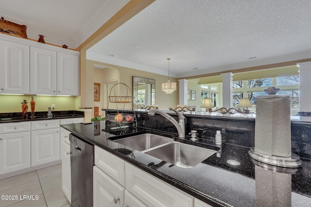 kitchen featuring white cabinetry, dark stone countertops, sink, and stainless steel dishwasher