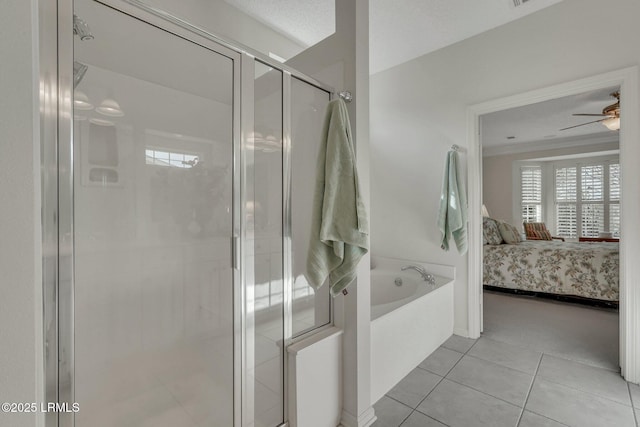 bathroom featuring ceiling fan, independent shower and bath, tile patterned flooring, and a textured ceiling