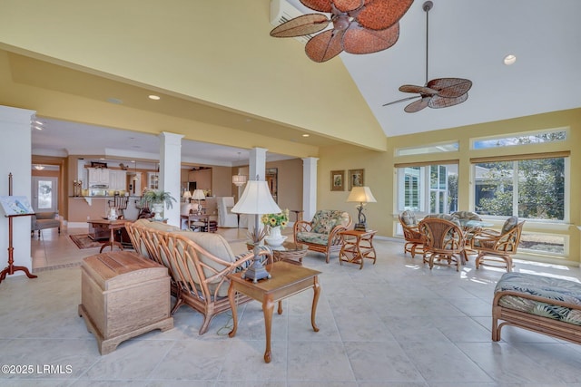 tiled living room featuring high vaulted ceiling, ceiling fan, and ornate columns