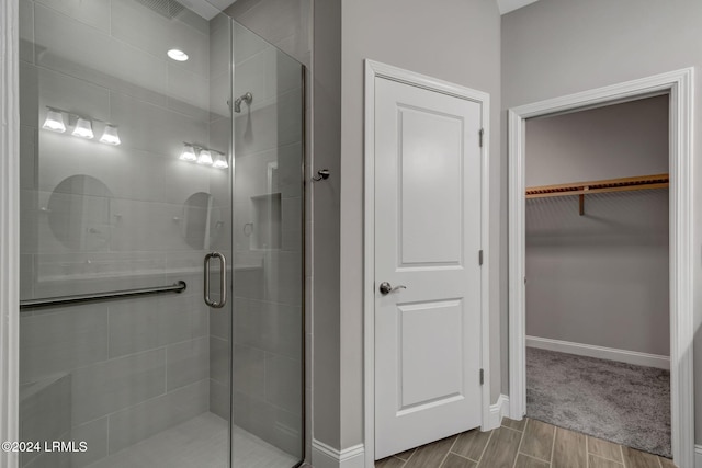 bathroom featuring a shower with shower door