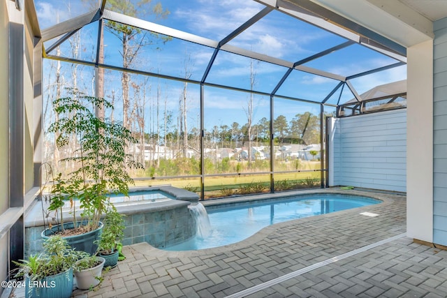 view of swimming pool with a patio, a lanai, and pool water feature