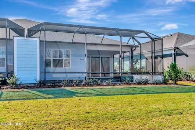 back of house featuring a yard and glass enclosure