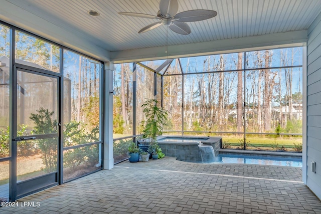 unfurnished sunroom featuring ceiling fan