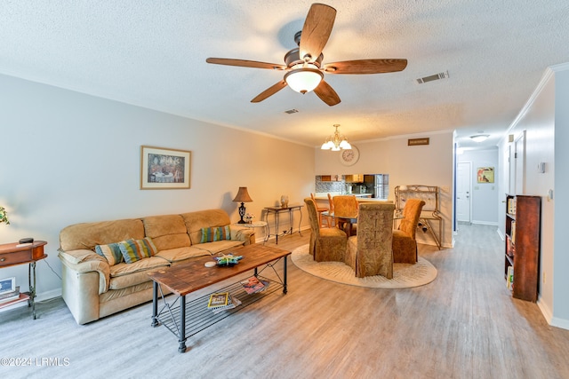 living room featuring hardwood / wood-style floors, crown molding, ceiling fan with notable chandelier, and a textured ceiling