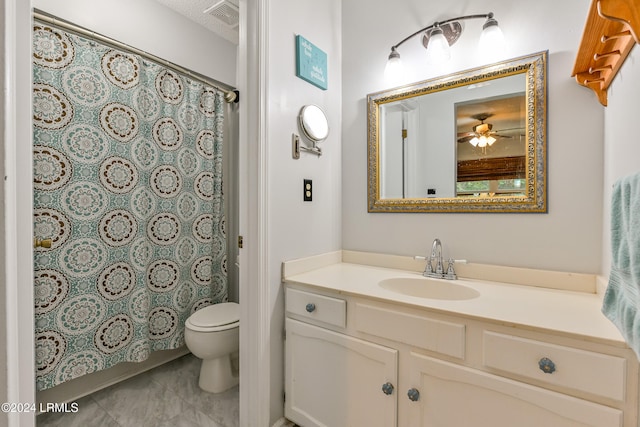 bathroom with vanity, ceiling fan, a textured ceiling, and toilet