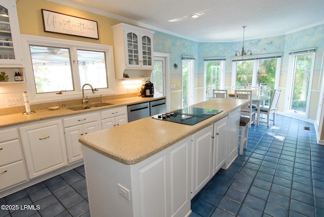 101 Ocean Point Dr, Fripp Island, SC 29920 - kitchen featuring a sink, stainless steel dishwasher, a center island, black electric cooktop, and glass insert cabinets