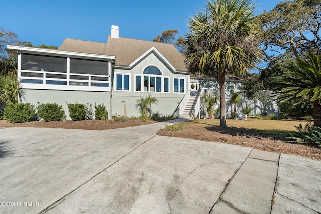 view of front of house featuring a sunroom