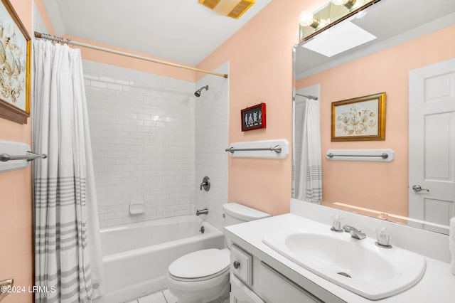 full bathroom with vanity, toilet, a skylight, and shower / bath combo