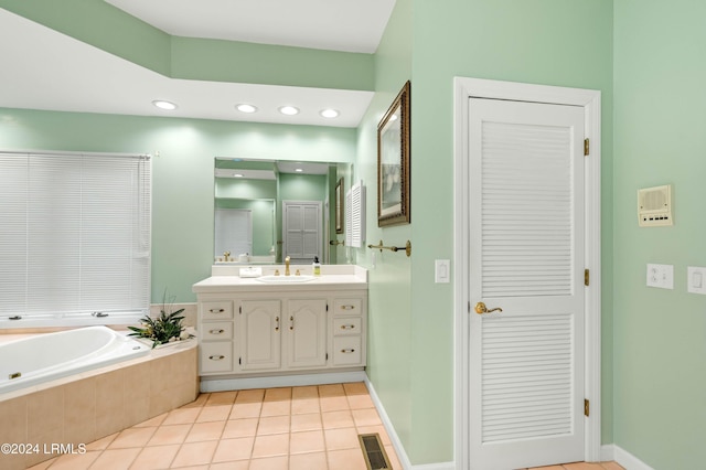 bathroom with vanity, tiled tub, and tile patterned floors