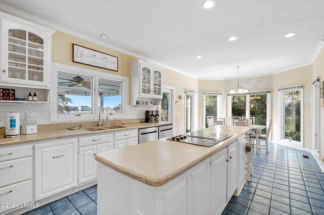 kitchen featuring sink, white cabinetry, decorative light fixtures, black electric cooktop, and a kitchen island