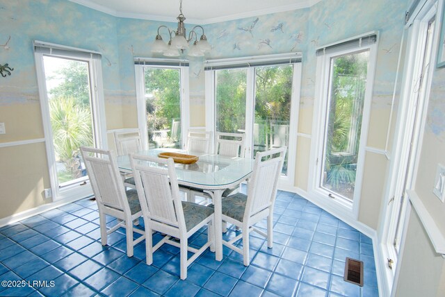 101 Ocean Point Dr, Fripp Island, SC 29920 - dining area with a chandelier, tile patterned flooring, wallpapered walls, and ornamental molding