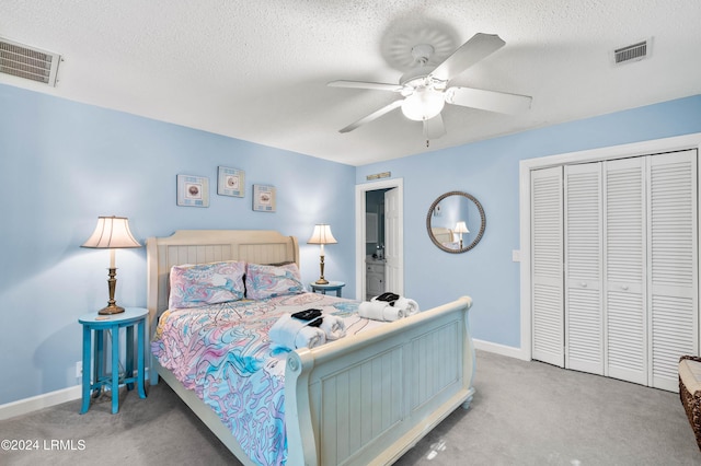 bedroom featuring ceiling fan, a closet, carpet, and a textured ceiling