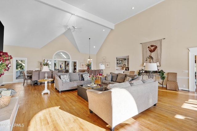 living room featuring beam ceiling, light hardwood / wood-style flooring, high vaulted ceiling, and ceiling fan