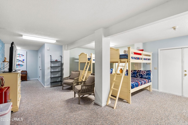 bedroom featuring carpet and a textured ceiling