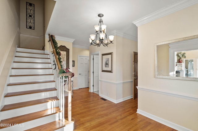 101 Ocean Point Dr, Fripp Island, SC 29920 - staircase with wood finished floors, a chandelier, crown molding, and baseboards