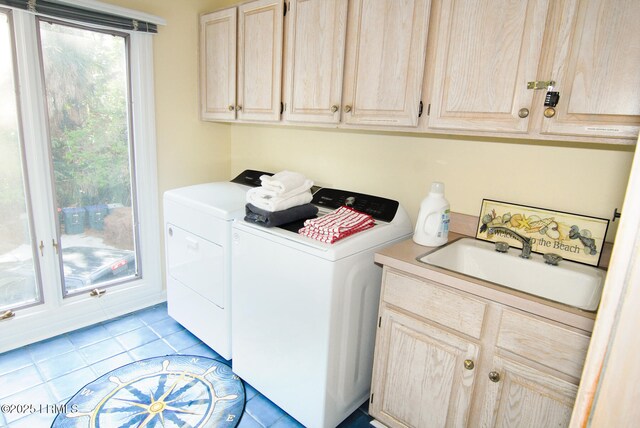 101 Ocean Point Dr, Fripp Island, SC 29920 - laundry room featuring washer and clothes dryer, cabinet space, and light tile patterned floors