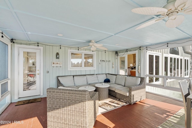 sunroom / solarium featuring ceiling fan