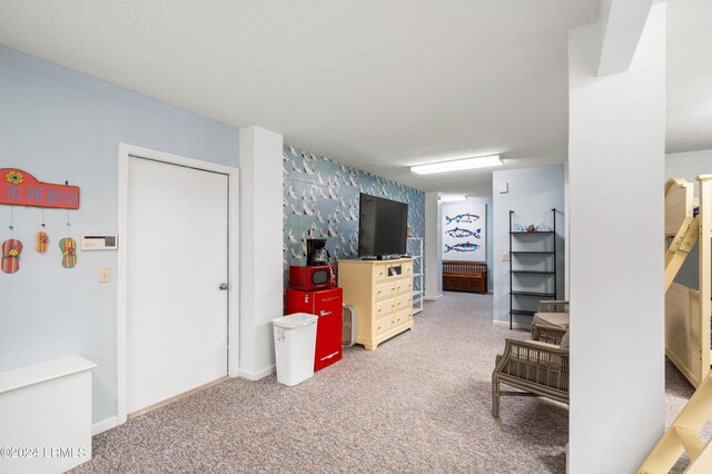 interior space featuring carpet flooring and a textured ceiling