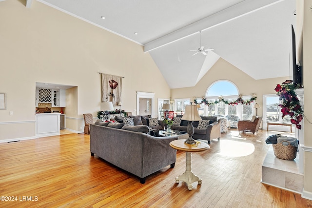 living room with high vaulted ceiling, ceiling fan, and light wood-type flooring