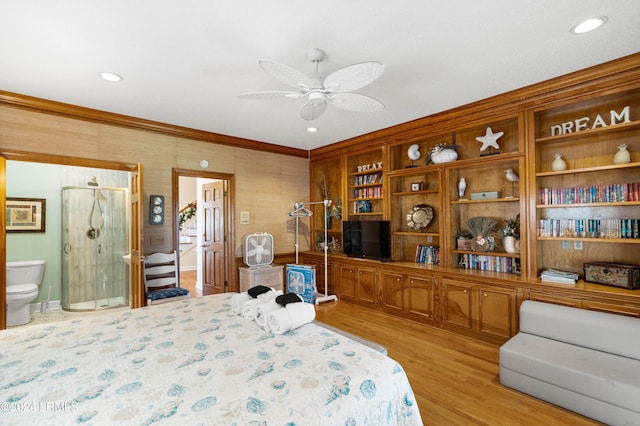 bedroom featuring connected bathroom, crown molding, and light hardwood / wood-style floors