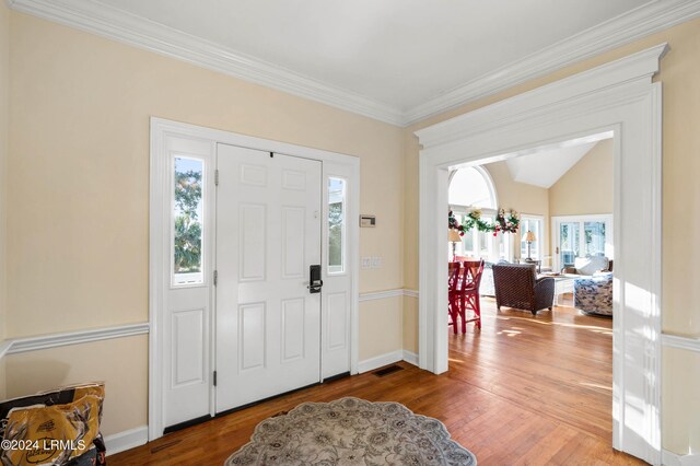 101 Ocean Point Dr, Fripp Island, SC 29920 - entrance foyer with wood finished floors, ornamental molding, baseboards, and lofted ceiling