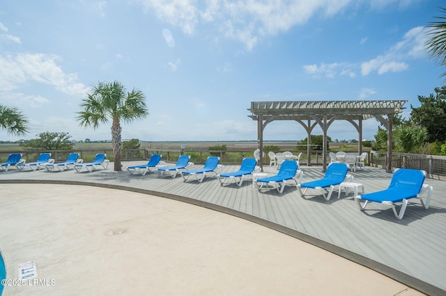 view of swimming pool with a pergola, a wooden deck, and fence