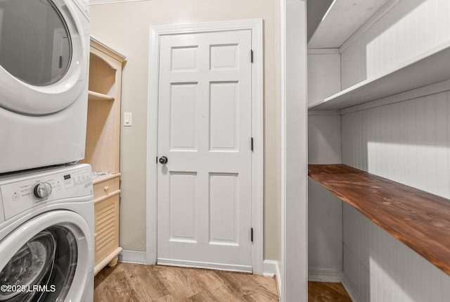 83 Sunset Blvd, Beaufort, SC 29907 - clothes washing area featuring stacked washer and dryer, wood finished floors, laundry area, and baseboards