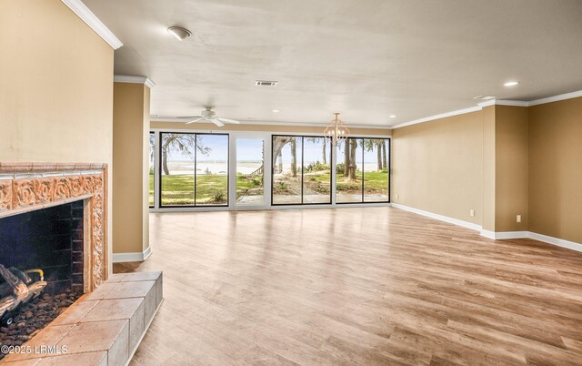 83 Sunset Blvd, Beaufort, SC 29907 - unfurnished living room featuring visible vents, light wood-style floors, baseboards, a tile fireplace, and ornamental molding