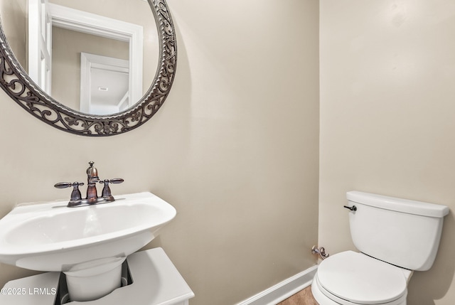 83 Sunset Blvd, Beaufort, SC 29907 - half bathroom featuring a sink, toilet, and baseboards