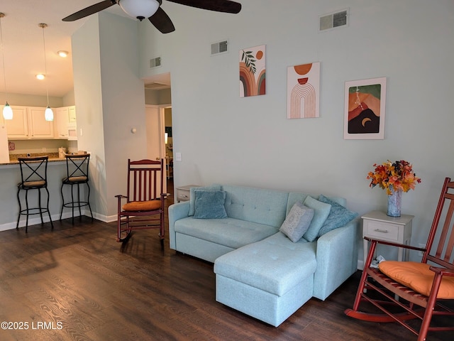 living room with dark wood-type flooring, ceiling fan, and high vaulted ceiling