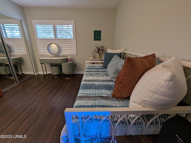 bedroom with dark hardwood / wood-style flooring