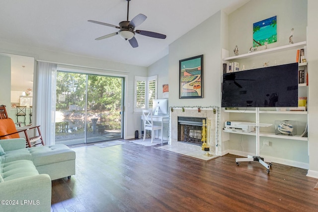 living room with vaulted ceiling, wood-type flooring, ceiling fan, and a fireplace